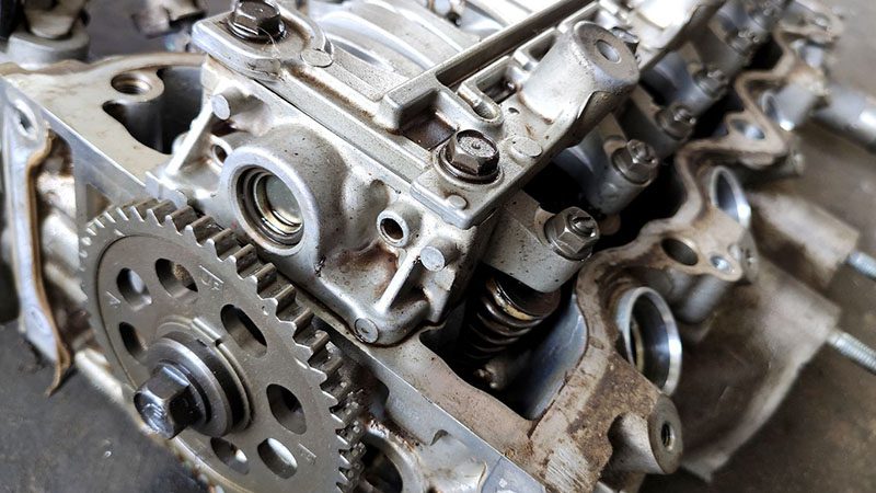 Old car engine prepared for rebuild in an automotive workshop.
