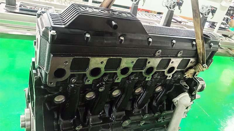 Back view of a Toyota 1HZ bare diesel engine showing rear components and connections.