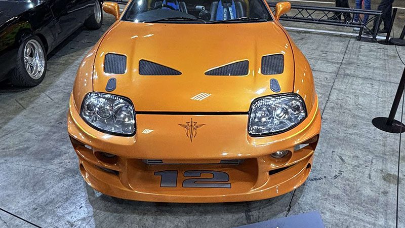 Front view of a Toyota Supra MK4 showcasing its iconic headlights and aggressive styling.