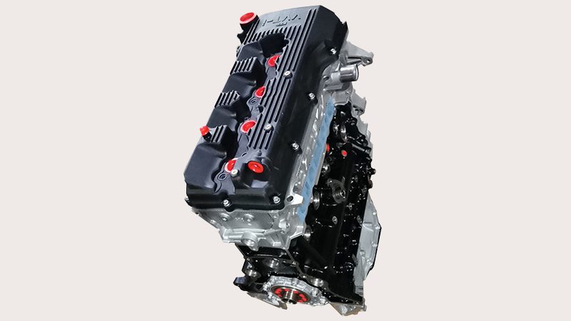 Top view of a Toyota 2TR engine showing valve cover and ignition coil layout