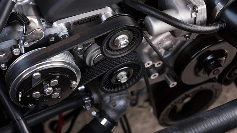Close-up view of a car engine, highlighting key components.