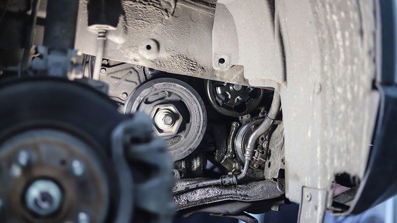 Oil leak from the engine sump, side view of the vehicle with the wheel removed—highlighting a common wet sump issue.