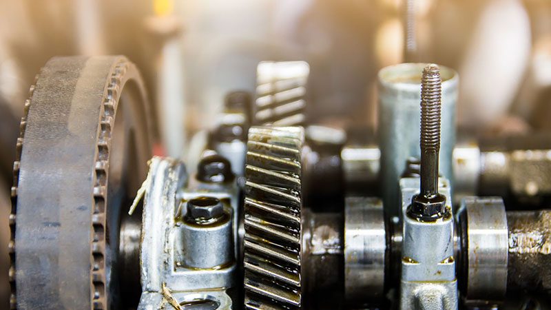 Close-up of an engine component highlighting the precision parts involved in Variable Valve Timing (VVT) systems.