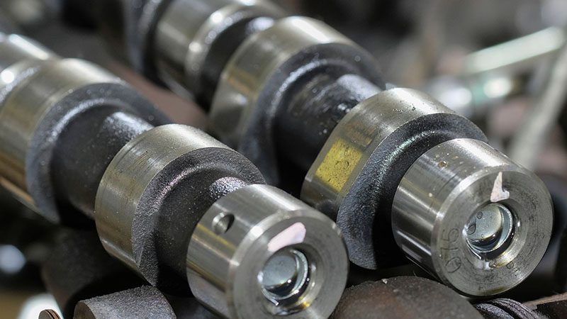 Close-up of engine camshafts, key components in controlling valve timing and improving engine performance.