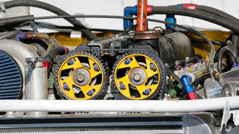 Close-up of an engine timing belt, a crucial part of the engine's timing system and Variable Valve Timing (VVT) performance.