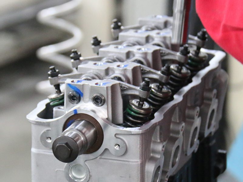 Técnico montando o cabeçote do cilindro durante a produção do motor na fábrica da Woda Auto.