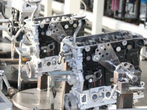 Auto engine production line with mechanics assembling engines at Nanjing Woda Auto Technology Co., Ltd.