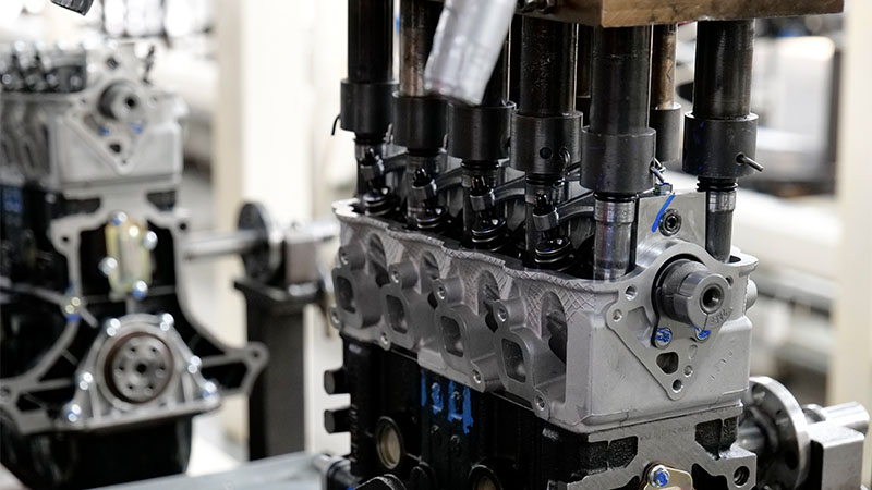 Cylinder head installed on an engine along the factory assembly line.