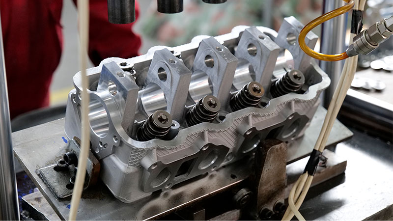 Close-up of a cylinder head assembly line.
