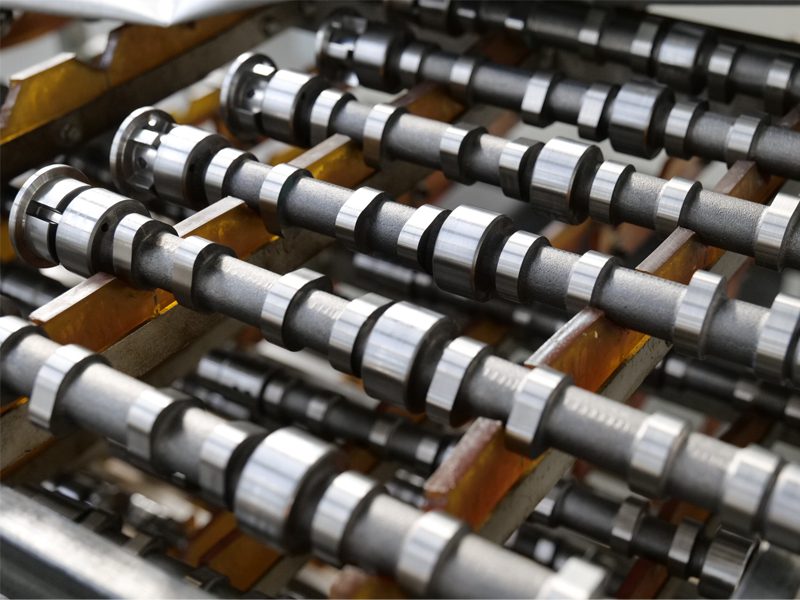 Auto engine parts factory at Nanjing Woda Auto Technology Co., Ltd., showcasing a display of precision camshafts.