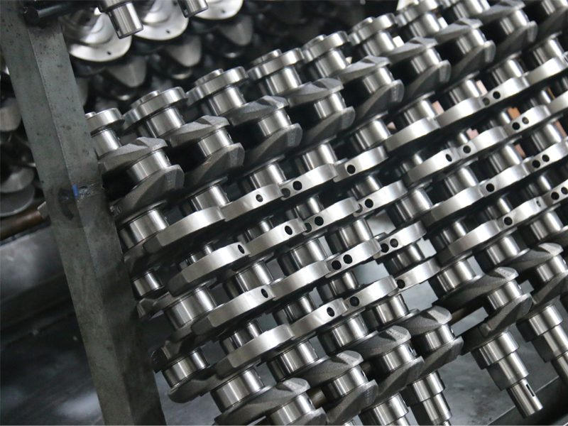 Auto engine parts factory at Nanjing Woda Auto Technology Co., Ltd., showcasing a display of high-quality crankshafts.
