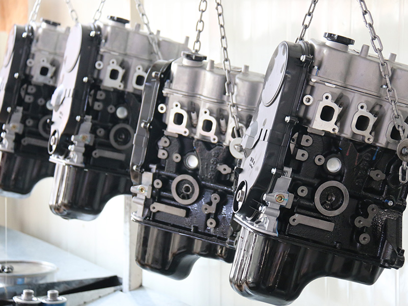 Automotive engine assemblies suspended on a factory production line.
