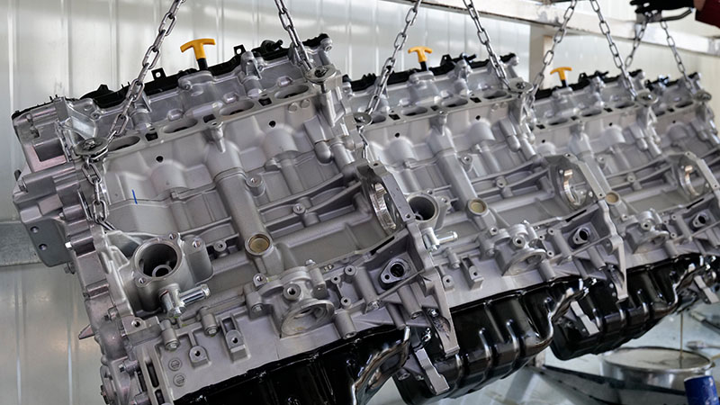 Rows of metal engine blocks arranged at an automotive manufacturing facility.