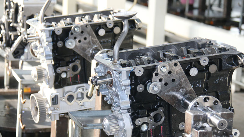 Multiple automotive engine assemblies arranged along a factory production line.