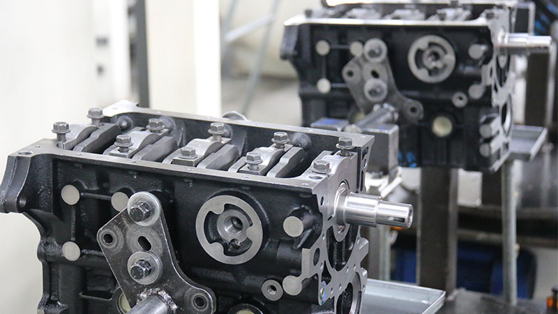 Partially assembled automotive engines positioned at an engine manufacturing facility.