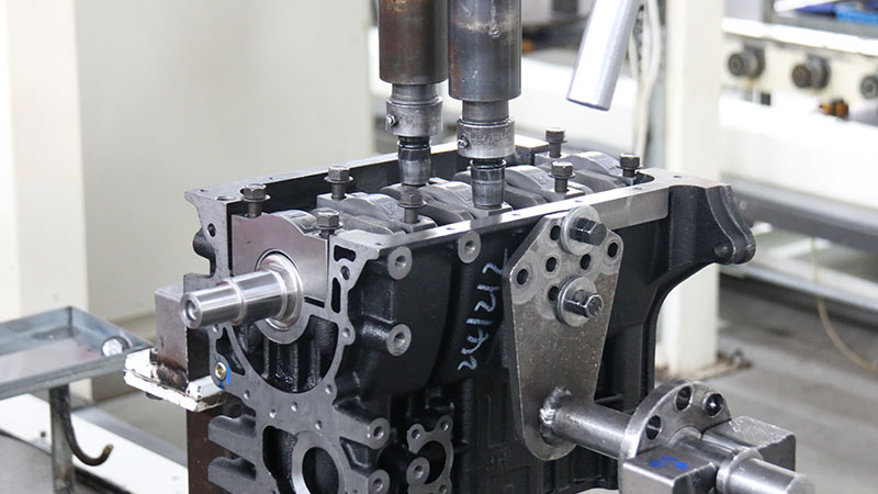 Engine component being inspected or processed using factory machinery.