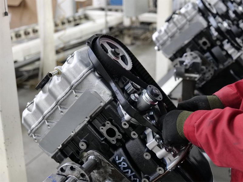 Auto engine production in progress, featuring advanced machinery and skilled assembly for high-performance engines.