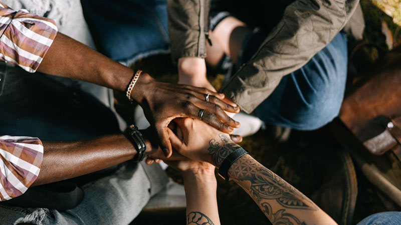 People with their hands together, symbolizing long-term partnership and collaboration in supplier relationships.