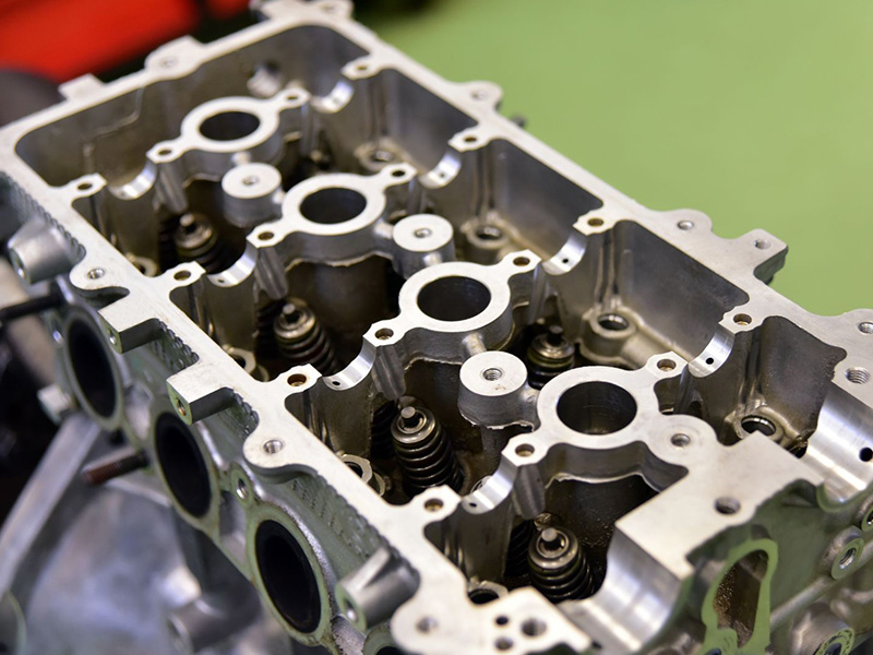 Close-up of a cylinder head showing the valves and combustion chamber components.