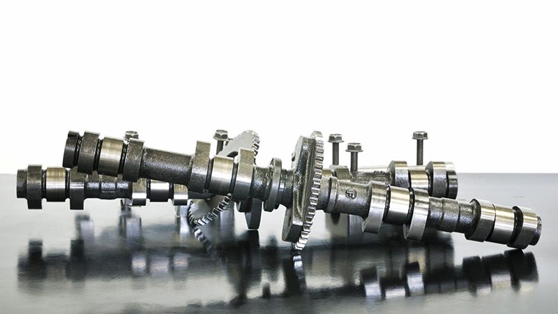 Close-up view of camshafts, showcasing their lobes and precision-machined surfaces used in internal combustion engines.