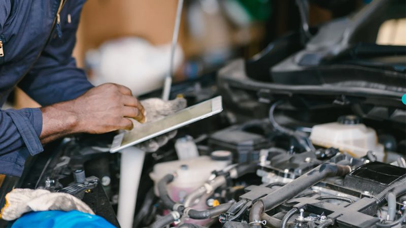 Mechanic performing an ECU tune-up using diagnostic equipment to optimize engine performance.