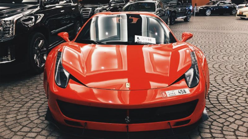 Front view of a sports car with aerodynamic design and sleek headlights.