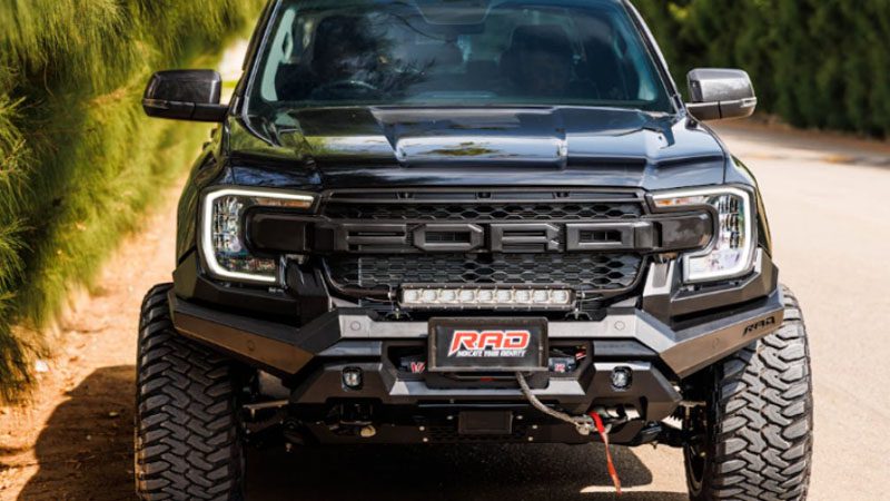 Front view of a pickup truck showcasing grille and headlights.