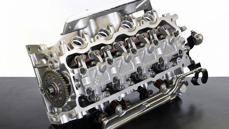 Assorted automotive engine parts laid out for maintenance or assembly.