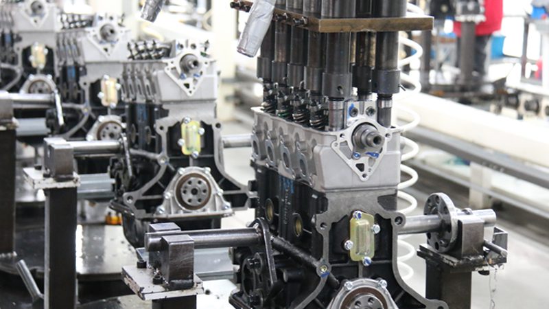Engine production line at our company's factory showing assembly of automotive engine components.