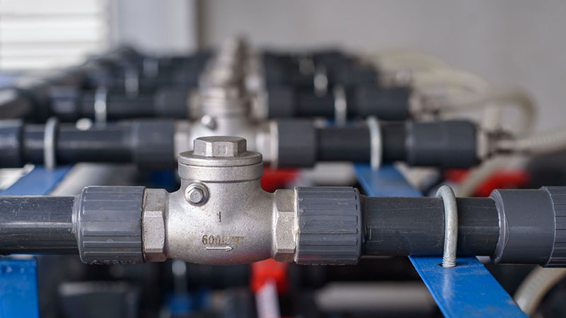 Check valve installed in a UPVC pipe to prevent reverse water flow.