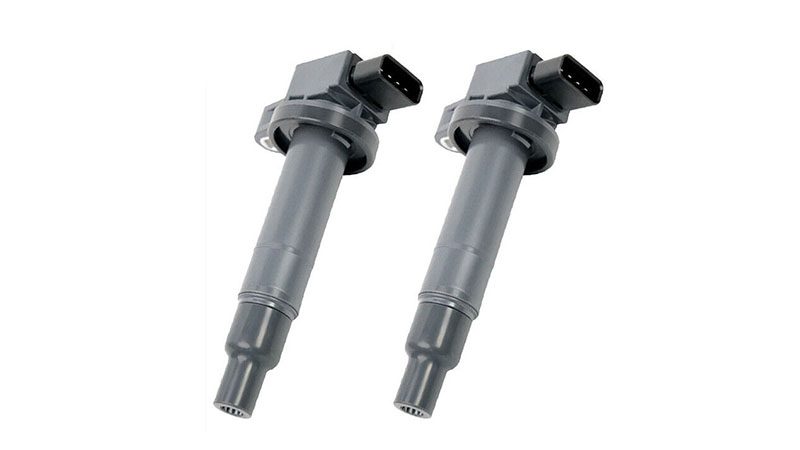 Close-up of new coil packs, highlighting their pristine condition and design.