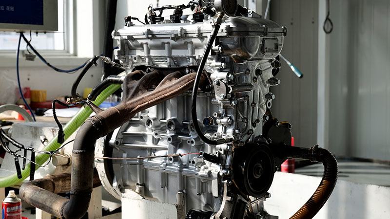 Close-up of an engine during a hot running test for performance and quality inspection.