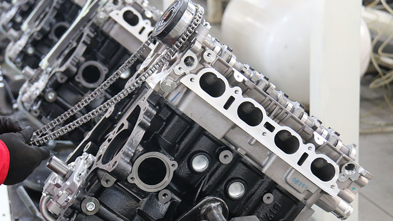 Close-up of an engine assembly line in a factory showing controlled production and quality inspection.