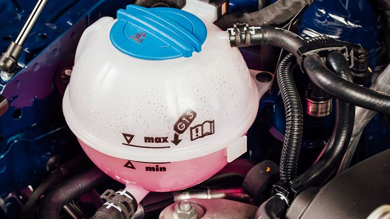 Close-up of a coolant tank in a car engine bay