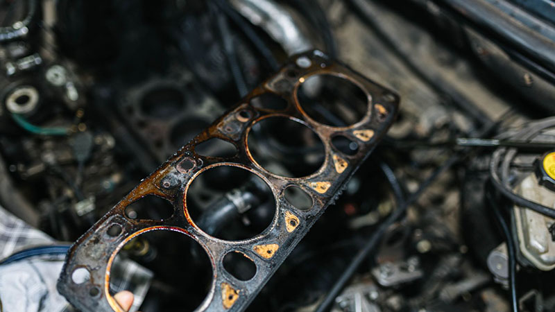 Engine head gasket being replaced during cylinder head repair.