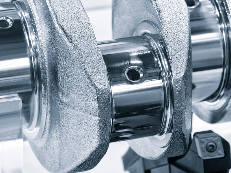 Close-up of a crankshaft showing machined journals and surface finish.