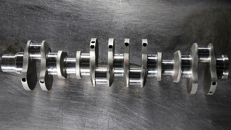 Engine crankshaft spare part for automotive engine repair and replacement.