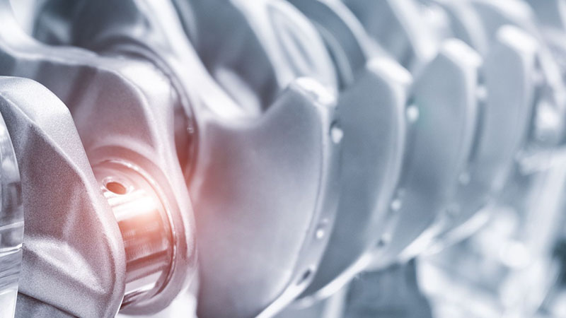 Engine crankshaft close-up for automotive industrial engineering and engine parts.