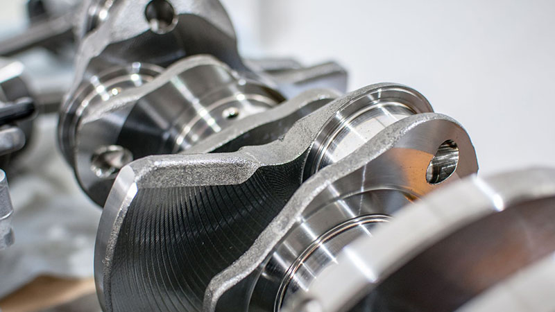 Close view of a crankshaft detail showing machined journals and surface finish.