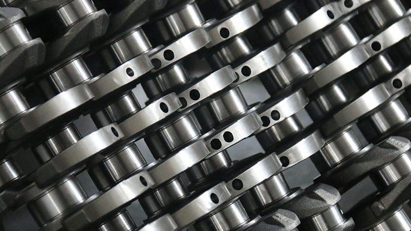Close-up of automotive crankshafts prepared for engine assembly in factory production.