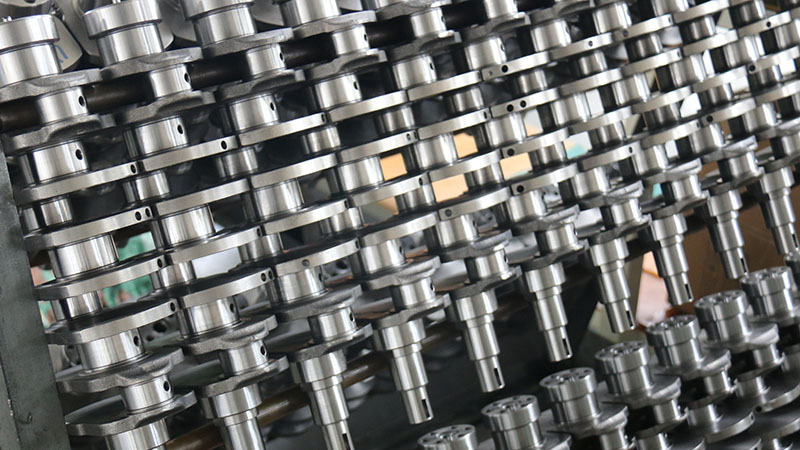 Multiple automotive crankshafts displayed for engine parts supply.