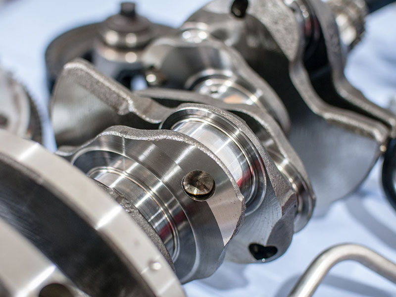 Close-up of a new crankshaft showing precision machined details