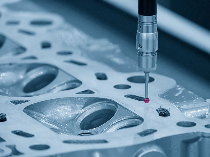 CMM machine measuring cylinder head parts for precision quality inspection.