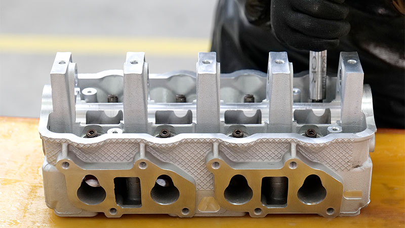 Cylinder head assembly line in automotive factory production.