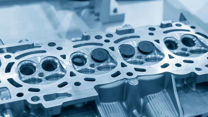 Aluminum cylinder head casting assembly with intake and exhaust valves installed.