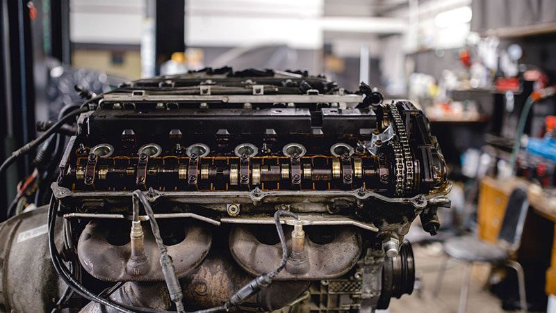Close-up view of a car engine undergoing repair with visible cylinder head components.