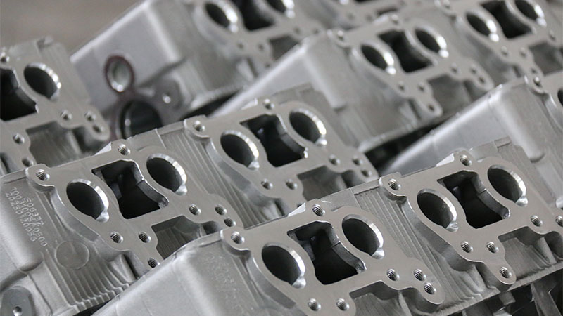 Detailed view of newly produced cylinder heads at an automotive factory.