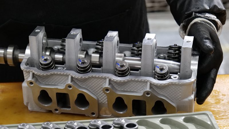 Cylinder head assembly line at Nanjing Woda Auto Technology Co., Ltd., showcasing precision manufacturing of engine components.