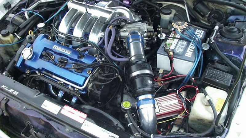 Close-up of a Mazda KL-ZE engine, highlighting its DOHC V6 configuration and performance-focused design.