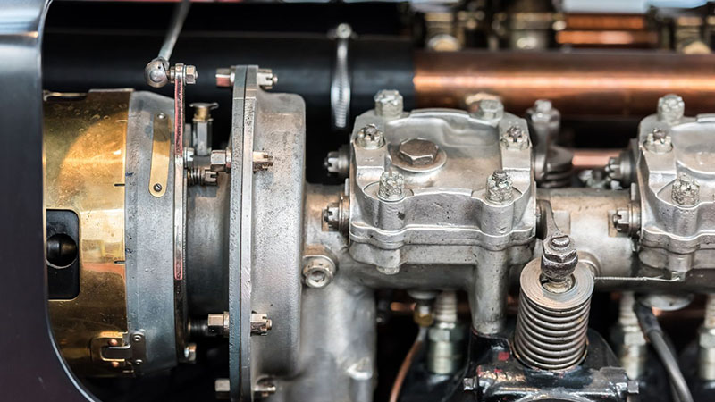 Close-up of old car internal combustion engine pistons connected to the cylinder head assembly.